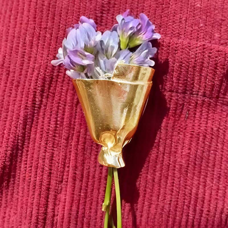 Draagbare bloemenbrochespeld